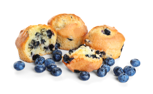 blueberry muffins, one cut open, blueberries placed around