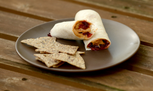 Review - Is Mr Tortilla 1 Carb Tortilla Keto Friendly? 7 keto peanut butter and jelly tortilla rolls, served on a grey plate, tortilla chips on the side