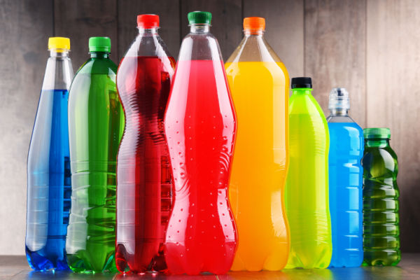 A table view of various sugary drinks in bottles.