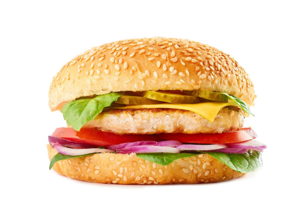 A front view of a chicken burger on a sesame seed bun. 