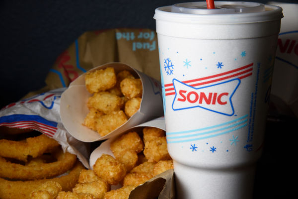 A photo of Sonic drink and other fried food items.
