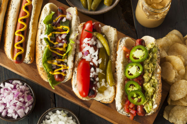 A top-down view of four American-style hot dogs in buns