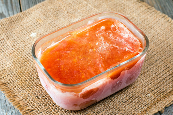 How to Make Bloves Sauce at Home: Recipe and Step-by-Step Instructions 6 A container filled with frozen Bloves Sauce, with ice crystals forming on the surface.