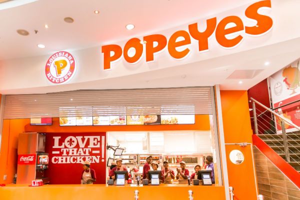 Photo of the interior of a Popeyes restaurant, showing the counter area.