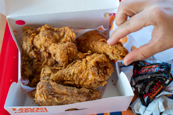 Photo of a box filled with the famous popeyes fried chicken.