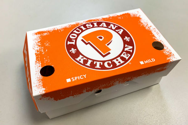Photo of a Popeyes box with the logo prominently displayed on the top.