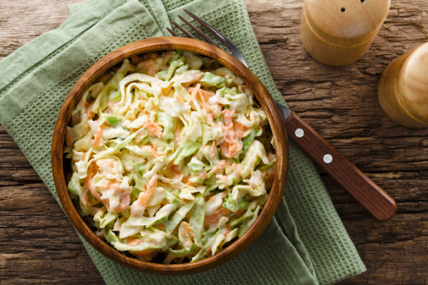 Photo of a bowl of coleslaw, a traditional side dish made with shredded cabbage, carrots, and a creamy dressing.