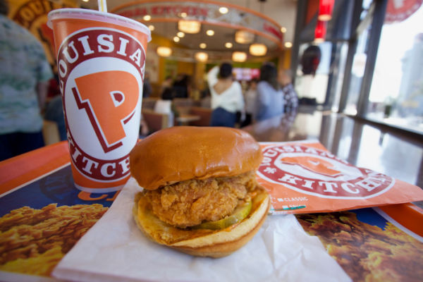 Photo of a delicious Popeyes burger and drink on a tray. 