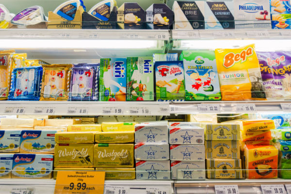 A photo of a grocery store display featuring various types of butter, including salted and unsalted butter and specialty flavored butters.