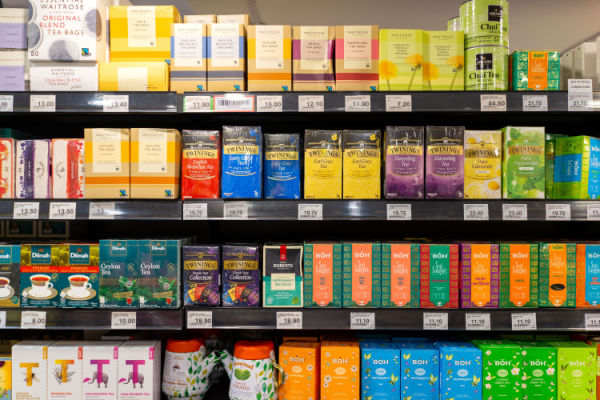 A photo of a grocery store display featuring a variety of teas, such as black, green, herbal, and specialty teas.