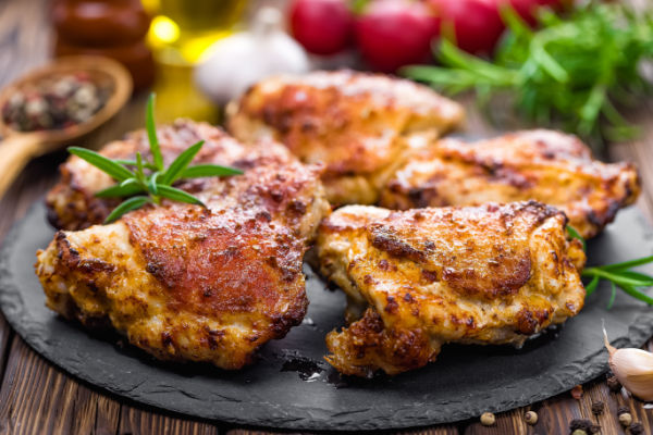 Photo of spicy chicken thighs with a crispy golden-brown exterior.
