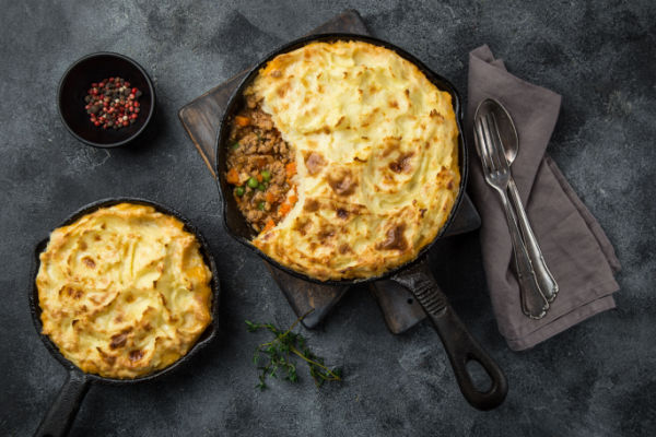 The Best Low Carb Shepherd's Pie Recipe that Will Blow Your Mind 3 A top view of a round baking pan containing two Shepherd's Pies