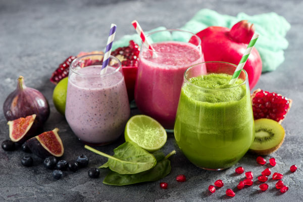 Keto Smoothie King Hacks: How to Customize Low-Carb Drink 7 A captivating photo showcasing three different smoothies in glasses, each adorned with a colorful straw.