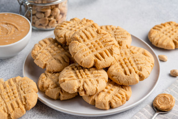 A delightful pile of peanut butter cookies, showcasing their signature crisscross pattern on top.