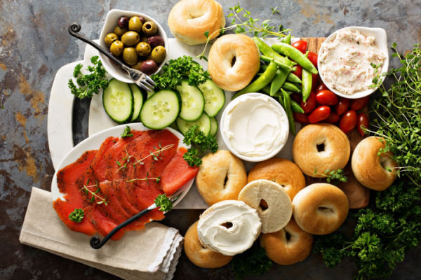 A platter of bread, and veggies with dips.