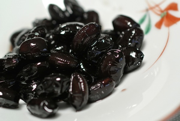 Are Refried Beans Keto? This Tasty Recipe Proves They Can Be 3 A close up of black soybeans served on a white flowery bowl