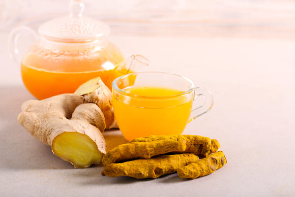 Make the Perfect Ginger Turmeric Shot at Home 9 Ginger tea and turmeric tea in cups