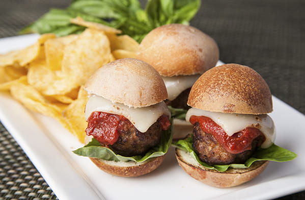 Mini burgers with meatballs, cheese, lettuce and catsup