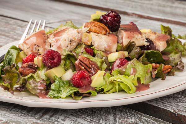 Zaxbys Low Carb: Unveiling the Best Kept Secret 6 A plate filled with a vibrant and fresh assortment of salad, featuring crisp lettuce, colorful vegetables, and a drizzle of dressing.