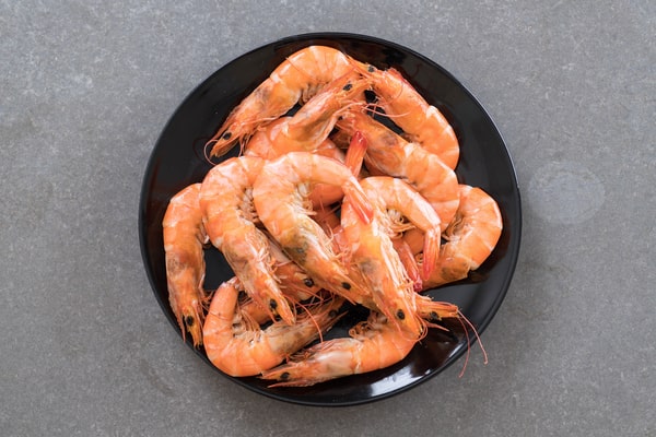 A top-down view of a plate filled with cooked shrimp, enticingly arranged and ready to be savored.