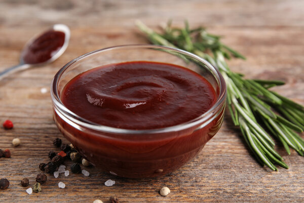 A bowl of BBQ sauce with herbs and spices