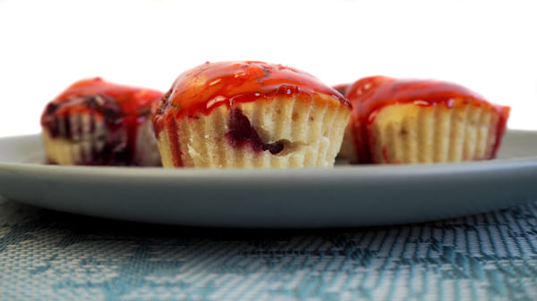 A scrumptious muffin oozing with sweet and tangy jam filling, adding a burst of flavor to every bite.