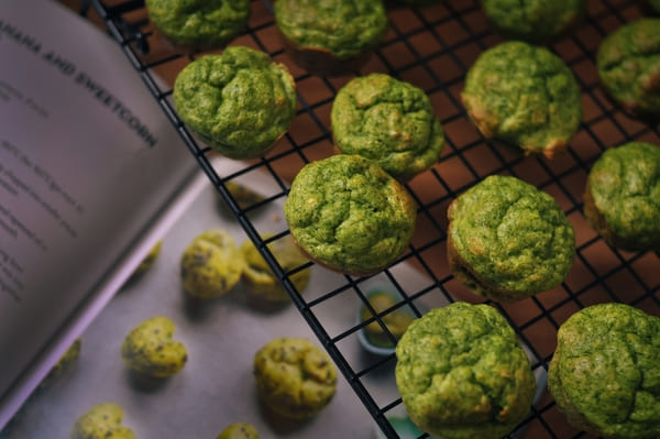 A visually striking photo showcasing vibrant green muffins, possibly made with ingredients like spinach, matcha, or other green vegetables, offering a unique and nutritious treat.
