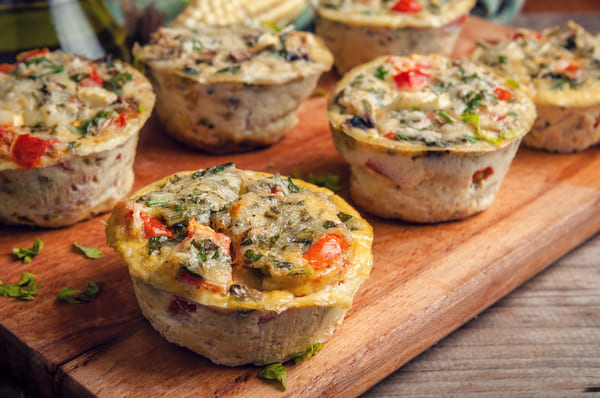 Delicious muffins made with an assortment of colorful vegetables, including carrots, zucchini, and bell peppers.
