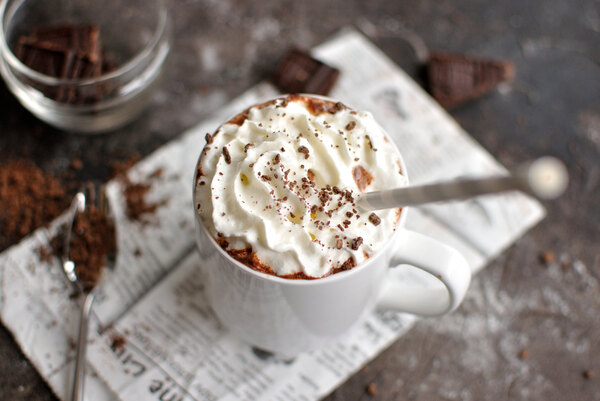 Hot chocolate topped with whipped cream and chocolate shavings