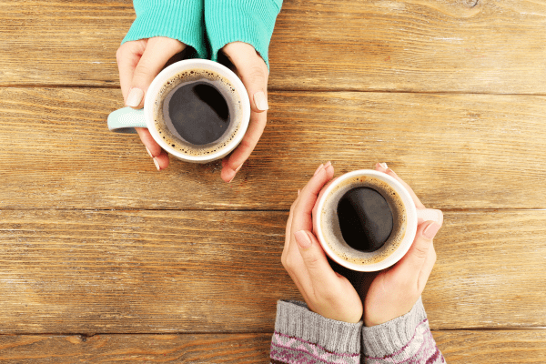 A top-down view of a cup of coffee, showcasing the rich color of the brew and the surface of the liquid.