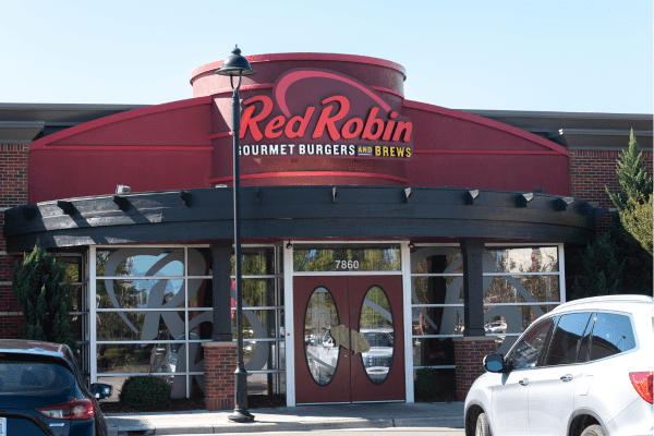 A photo of the front exterior of a Red Robin Gourmet Burgers restaurant, displaying the distinctive red signage and inviting entrance.