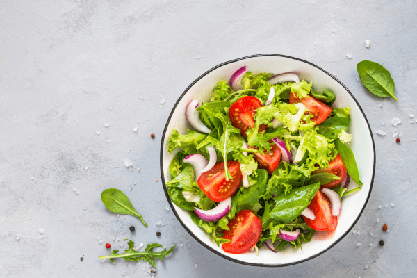 A photo of a plate filled with a colorful and appetizing salad, presenting a nutritious and visually pleasing dish.