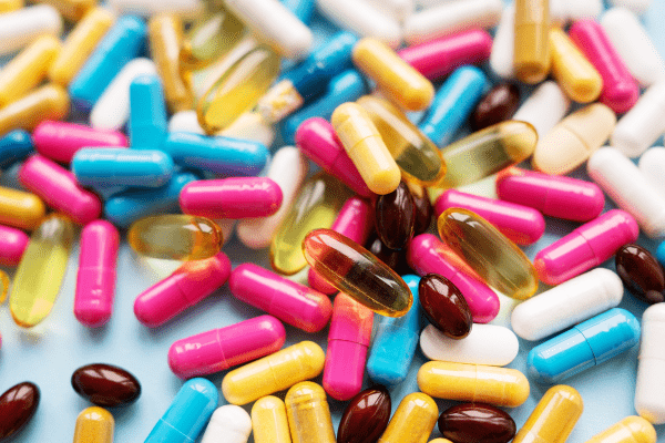 Is the One Shot Keto Diet Safe and Effective? Unraveling the Facts 9 Pills of various colors scattered, showcasing a diversity of medications or supplements.