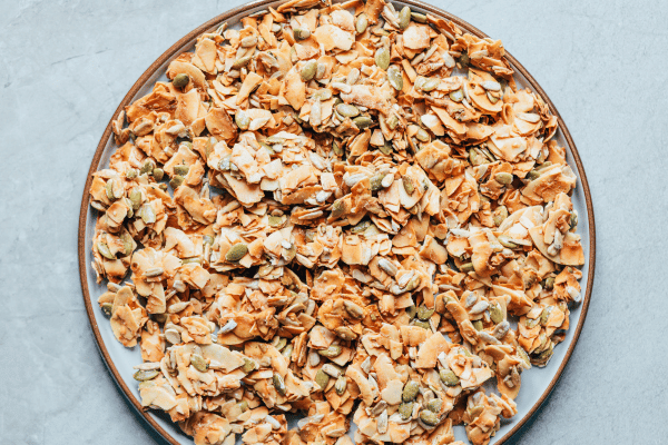 Are Keto Coconut Clusters a Healthy Snack Choice? 3 Coconut clusters arranged generously on a large plate, a tempting and delightful snack.