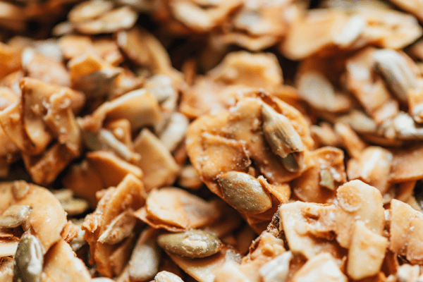Are Keto Coconut Clusters a Healthy Snack Choice? 8 A close-up view of a coconut cluster with crunchy peanuts, showcasing the delicious combination of sweet coconut and nutty goodness.