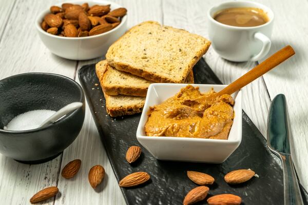 American Dream Nut Butter: Guilt-Free Gourmet Spreads Await 5 Almond butter and slices of bread with almonds and a cup of coffee