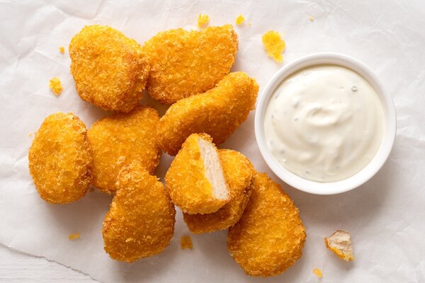 Homemade chicken nuggets with white sauce for dipping