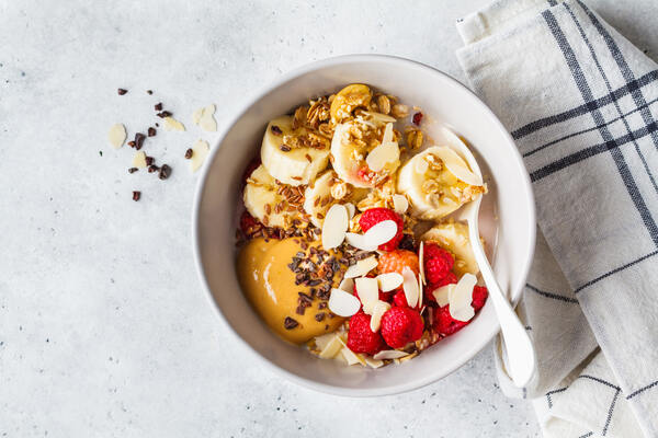 American Dream Nut Butter: Guilt-Free Gourmet Spreads Await 7 A bowl of granola with peanut butter, oats, berries, and almond slices