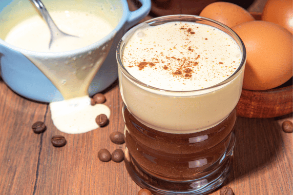 Vietnamese Egg Coffee, a unique and indulgent beverage consisting of strong Vietnamese coffee topped with a creamy and sweet egg yolk mixture, creating a rich and decadent flavor profile.