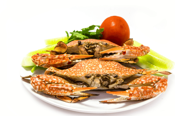 A plate of Dungeness crabs, showcasing the distinct appearance and delectable taste of this popular seafood dish.