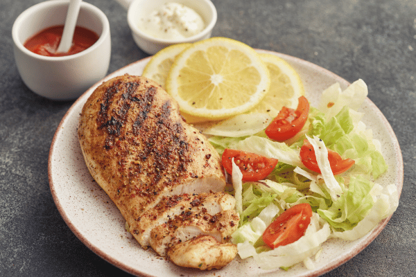 10 Keto Chicken Breast Recipes for a Vibrant Lifestyle 3 Keto Chicken Breast Recipes: Chicken breasts are expertly cooked and served with flavorful side dishes, presenting a well-prepared and delicious meal.