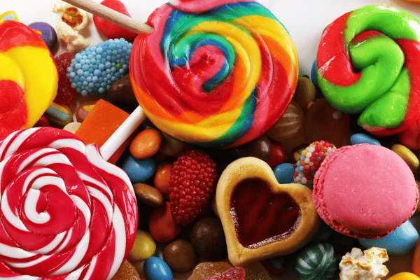 The Ultimate Russel Stover Sugar Free Experience 3 A delightful display of assorted candies and chocolates, showcasing a burst of colors and a tempting variety of sweet treats in a festive arrangement.