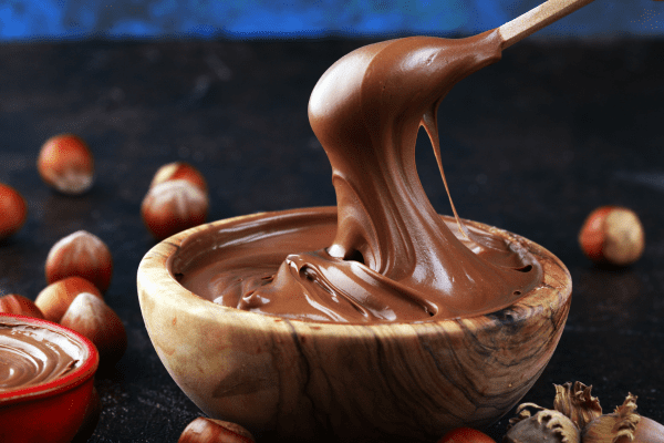 Sugar Free Nutella: Satisfy Your Sweet Tooth Guilt Free 3 A delectable bowl of sugar free Nutella, spooned and ready to be enjoyed, showcasing the rich and creamy texture of this popular hazelnut chocolate spread.