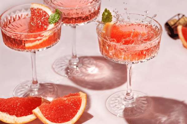 Pink Whitney Carbs: Delicious pink cocktails garnished with citrus slices on the sides, offering a visually appealing and refreshing beverage experience.