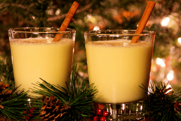 Keto Eggnog 101: A Complete Recipe Guide for the Holidays 4 A festive Christmas setup featuring glasses of eggnog, adorned with holiday cheer, presenting a warm and inviting scene for seasonal celebrations.