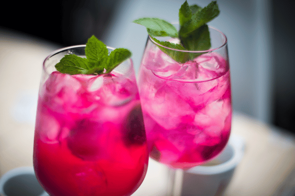 Pink Whitney Carbs: Vibrant pink drinks are elegantly presented in a glass, promising a visually delightful and refreshing beverage experience.