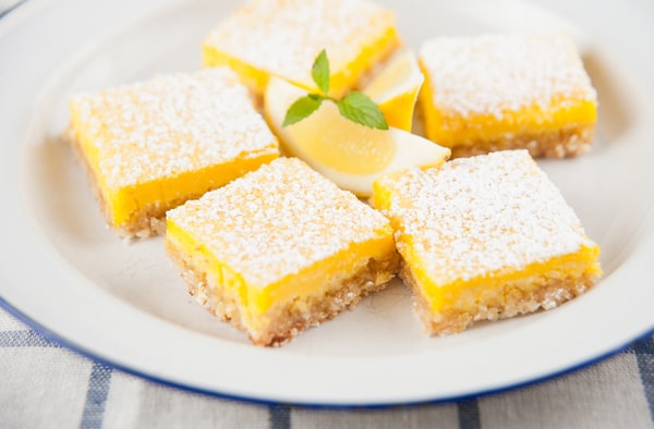 Keto Cook Out Delights: Irresistible Recipes for Your Feast 15 Lemon bars with a slice of lemon on a plate