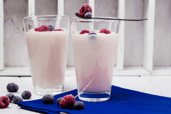 Best Keto Yogurt: Two glasses of yogurt adorned with a vibrant assortment of fresh berries, creating a visually appealing and nutritious treat.