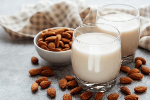 Lowest Carb Almond Milk: Sip Smart With This Keto Delight 4 Lowest Carb Almond Milk: Two glasses of almond milk, a popular dairy alternative, offering a nutritious and plant-based beverage option.