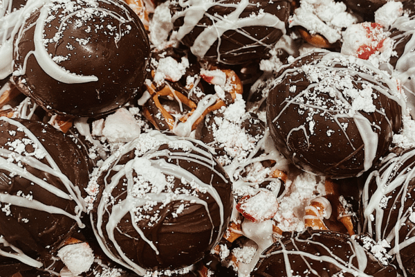 Hot keto chocolate bombs, are a delightful and low-carb treat, showcasing a sphere of rich chocolate filled with keto-friendly ingredients, ready to be melted into a warm and indulgent beverage.